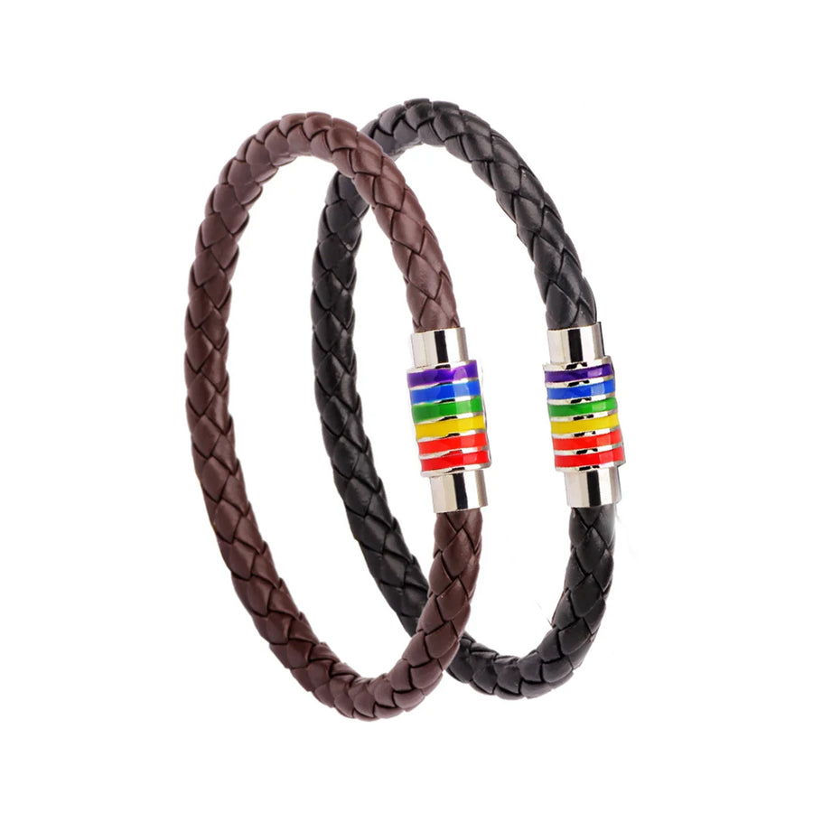 Zwei geflochtene Armbänder aus Leder, eines in Braun und eines in Schwarz, mit silbernen Verschlüssen und Regenbogen-Details, symbolisch für LGBTQ+ Stolz und Vielfalt.